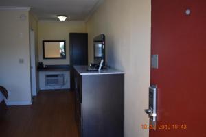 a room with a desk with a computer on top of it at Rockview Inn and Suites in Morro Bay