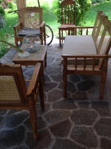 a group of chairs and tables on a stone patio at Hotel y Bungalows ecologicos Marcelo in Santiago Atitlán