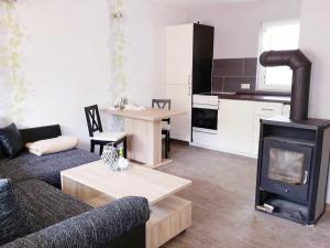 a living room with a couch and a stove at Ferienhaus Bielenski in Blankenburg