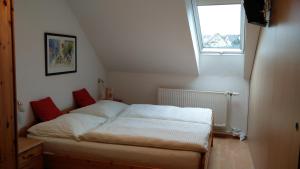 a small bedroom with a bed in a attic at Pension & Reitstall Inghofer in Heidenreichstein
