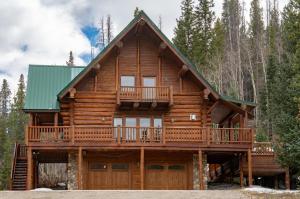 a log cabin with a wrap around deck at Elk Meadow Lodge in Breckenridge