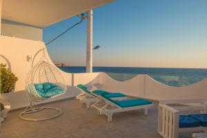 a porch with a hammock and a view of the ocean at Aristodimos Luxury Suite in Kalamaki Heraklion