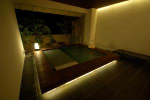 a room with a swimming pool with lights on the floor at Kawayu Onsen Fujiya in Hongu