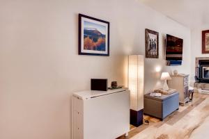 a room with a desk with a laptop on a wall at Cedar Lodge Peak One Studio Condo: Downtown Frisco in Frisco