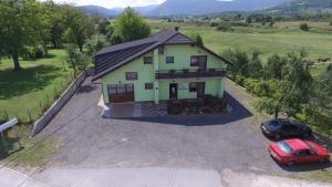 an aerial view of a house with a car at Green apartment Plitvice in Rakovica