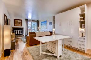 a bedroom with a bed and a desk in a room at Cedar Lodge Peak One Studio Condo: Downtown Frisco in Frisco +21 photos