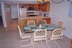 a kitchen with a table and chairs and a kitchen with a kitchen at Sungate 402 in Ocean City