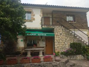 a building with a table in front of it at Agerre Goikoa Agroturismo in Zarautz