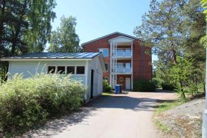 a building with a garage next to a building at Hamina Orange Apartments Ilves in Hamina