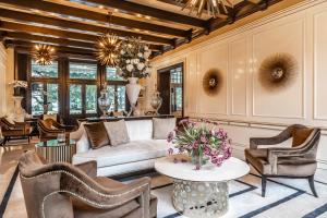 a living room with a couch and chairs and a table at Villa Eden a member of Leading Hotels of the World in Merano