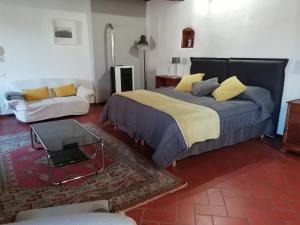 ein Schlafzimmer mit einem Bett und einem Sofa in der Unterkunft Il ghiro in Montevarchi