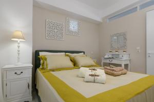 a bedroom with a bed with yellow and white at Kouses Estate close to Matala, Komo beach & Faistos in Kousés