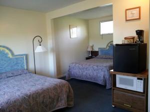a bedroom with a bed and a television at Ocean Avenue Inn in Westport