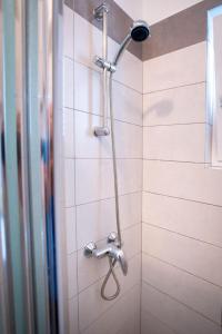 a shower with a shower head in a bathroom at Apartments Marija - good location in Supetarska Draga