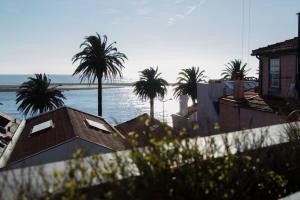 a view of a beach with palm trees and the ocean at Home Of The Poet in Porto