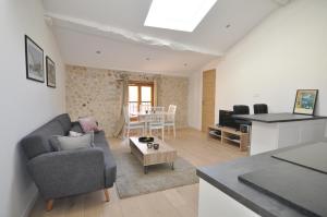 a living room with a couch and a table at Splendid one-bedroom apartment - Picasso 3 - StayInAntibes in Antibes