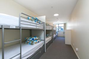 a hallway with bunk beds in a dorm room at Hobson Lodge in Auckland