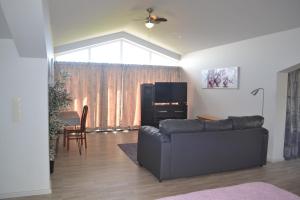 a living room with a leather couch and a table at Casa Grande in Angra do Heroísmo