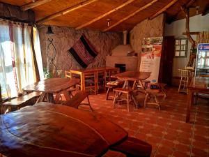 a room with wooden tables and chairs in a building at Hostal Elim in San Pedro de Atacama