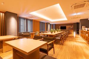 a restaurant with tables and chairs in a room at Hotel Vista Premio Kyoto Nagomi tei in Kyoto