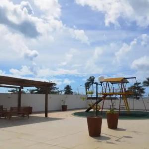 a playground with a picnic table and a bench at Condomínio Solaris residencial Club in Ilhéus