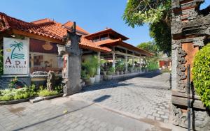 a street in front of a building with a restaurant at Adi Dharma Hotel Legian in Legian