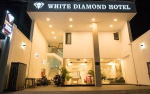 - un hôtel en diamant blanc éclairé la nuit dans l'établissement White Diamond Hotel - Airport, à Hô-Chi-Minh-Ville