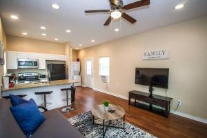 a living room with a couch and a flat screen tv at Douglas Way Remodeled House Near Downtown 1BA/1BA in San Antonio