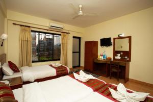 Ένα ή περισσότερα κρεβάτια σε δωμάτιο στο Hotel Orchid