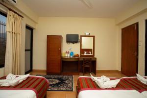 Ένα ή περισσότερα κρεβάτια σε δωμάτιο στο Hotel Orchid