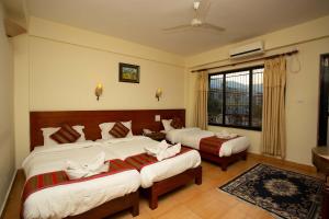 Ένα ή περισσότερα κρεβάτια σε δωμάτιο στο Hotel Orchid