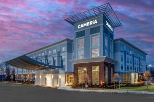 
a building with a clock on the front of it at Cambria Hotel West Orange in West Orange
