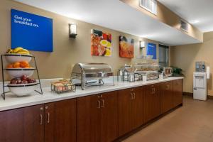 a kitchen with a counter with food on it at Comfort Inn Ocala Silver Springs in Ocala