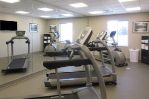 a gym with several cardio machines in a room at Sleep Inn & Suites Oregon - Madison in Oregon