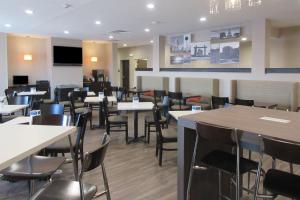 a dining room filled with tables and chairs at Sleep Inn & Suites Oregon - Madison in Oregon