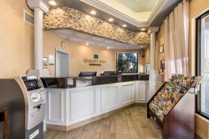 a counter in a store with a cash register at Quality Inn Boca Raton University Area in Boca Raton