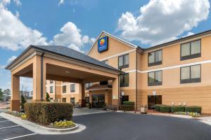 a hotel with a parking lot in front of it at Comfort Inn & Suites Peachtree Corners in Norcross