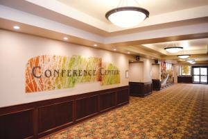 a large lobby with a conference center sign on the wall at Quality Inn & Suites Ames Conference Center Near ISU Campus in Ames