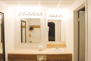 a bathroom with a sink and a mirror at Quality Inn & Suites Ames Conference Center Near ISU Campus in Ames