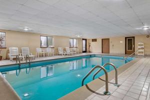 a swimming pool with chairs and tables in a building at Quality Inn & Suites Lebanon I-65 in Lebanon