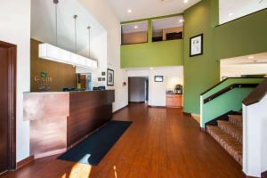 eine Lobby mit einer Treppe und grünen Wänden in der Unterkunft Quality Inn in Grasonville
