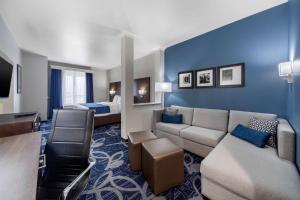 a hotel room with a couch and a bed at Comfort Inn & Suites Oklahoma City in Oklahoma City