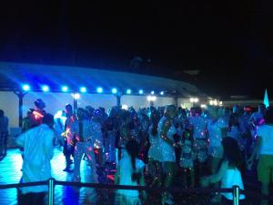 a group of people standing in a crowd at night at Vikingen Infinity Resort & Spa in Avsallar +23 photos