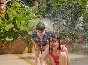 a boy and a girl playing in the water at PARKROYAL Penang Resort in Batu Ferringhi