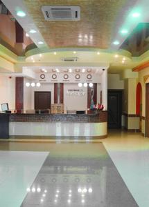 a large lobby with a waiting area and a counter at Hotel Orenburg in Orenburg