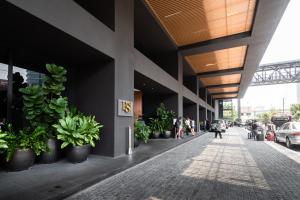 吉隆坡的住宿－EST Suites Bangsar by Airhost，旁边是种盆栽植物的建筑