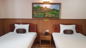 Postel nebo postele na pokoji v ubytování Phadaeng Hotel