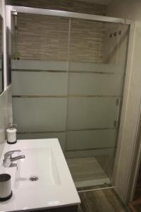 a bathroom with a sink and a shower at Casa MENDILUCE in El Pueyo de Jaca