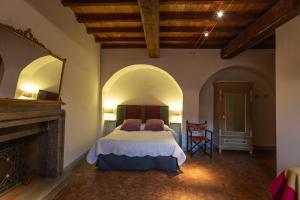 a bedroom with a bed in a room with a fireplace at Sant'Angelo 42 in Orvieto