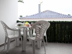 a white table and chairs on a patio at Casa Anna in Caleta De Fuste